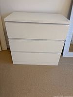 Front view of white 3-drawer dresser