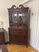 front view of mahogany china cabinet showing glass doors and drawers