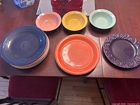Full lot showing stacked plates, separate plates and three bowls