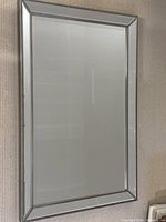 Full view of rectangular mirror mounted on wall