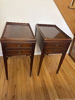 Two matching wooden side tables front view