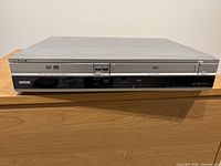 Front view showing Sony branding, DVD tray, VHS slot