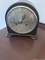 Front view of Smiths Enfield mantle clock showing dial and bezel