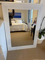 Front view of entire mirror leaning against wall