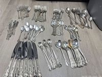 Full layout of all flatware pieces in groups on floor