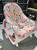 Front angled view of baby rocker showing overall design and fabric pattern