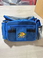 Front view of blue/gray cooler-tackle bag with Bass Pro Shops XTREME 360 Qualifier patch