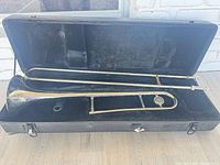 Trombone in open case showing full instrument and interior lining