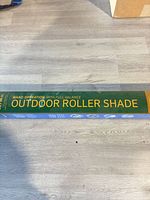 Front of boxed Coolaroo outdoor roller shade