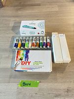 All items laid out: Scrib3D pen box, tray of small paint tubes, two large paint tubes boxed, DIY kit