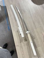 Sword and scabbard laid out showing full length
