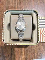 Top view of Fossil ladies stainless steel watch in original tin box