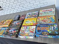 Tabletop view showing all 10 boxed games and Laser X sets
