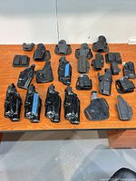 Overview of all holsters and pouches on table