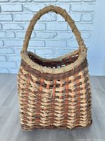 Front view of woven wicker basket with handle