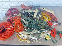 Pile of assorted extension cords, power strips and adapters