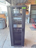 Front view showing glass door, shelves and casters