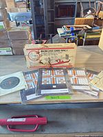 Boxed MTM maintenance center with all six sealed target packs on table