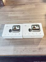 Two sealed VEIU smart video doorbell boxes on tabletop