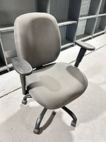 Front view of grey rolling office chair