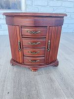 Closed wood jewelry cabinet front view