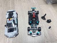 Both assembled LEGO Mercedes-AMG cars side by side, showing overall condition