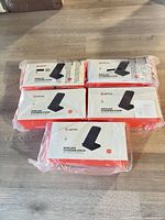 Five shrink-wrapped Griffin wireless charging stand boxes