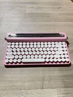 Front view of pink wireless keyboard with tablet stand