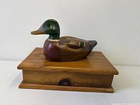 duck decoy on wood box front angle