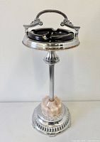 Full view of chrome and glass floor ashtray front