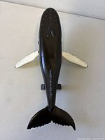 Top view of carved wood humpback whale showing overall form and plinth