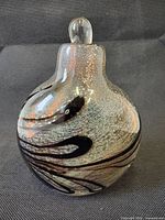 Front view of bulbous art glass perfume bottle with stopper inserted