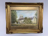 Front view of gilt framed watercolor depicting church scene