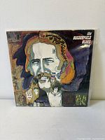 Front cover of the LP in plastic sleeve