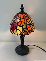 Full view of lamp showing stained glass shade and base