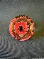 Top view showing red poppy flower inside paperweight
