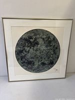 Front view of framed circular artwork