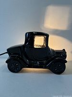 Left side view of black ceramic sedan car lamp, light on