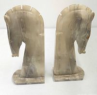 Front view of both marble horse head bookends standing upright