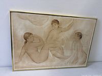 Framed Renoir "Three Bathers" print leaning against wall