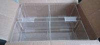 Four acrylic bins inside shipping box