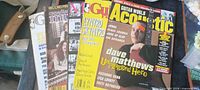 Three magazines overlapped: Guitar for the Practicing Musician, unidentified guitar magazine, Guitar World Acoustic
