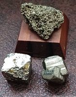 Iron pyrite cluster on wooden base with two standalone cubes