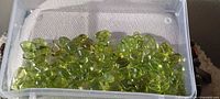 Tray of polished light green peridot stones