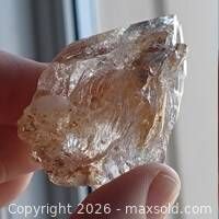 Three-quarter view of quartz specimen showing etched faces and inclusions