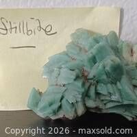 Front view of green stilbite crystal with label