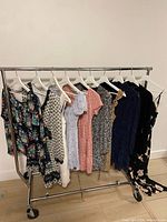 Full view of rack with 10 dresses on white hangers