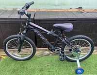 Left side view of CCM Ruckus kids bicycle showing frame, wheels, brakes, and training wheels