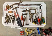 Tray of assorted hand tools including drill bits, hammers, wrenches, pliers, screwdrivers