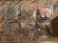 Six sleeves each containing several Canadian pennies